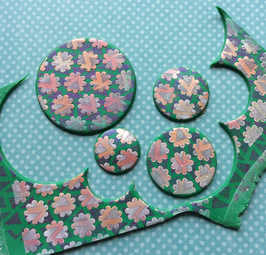 Create layered complex veneers on polymer clay using stencils, mica, and paint