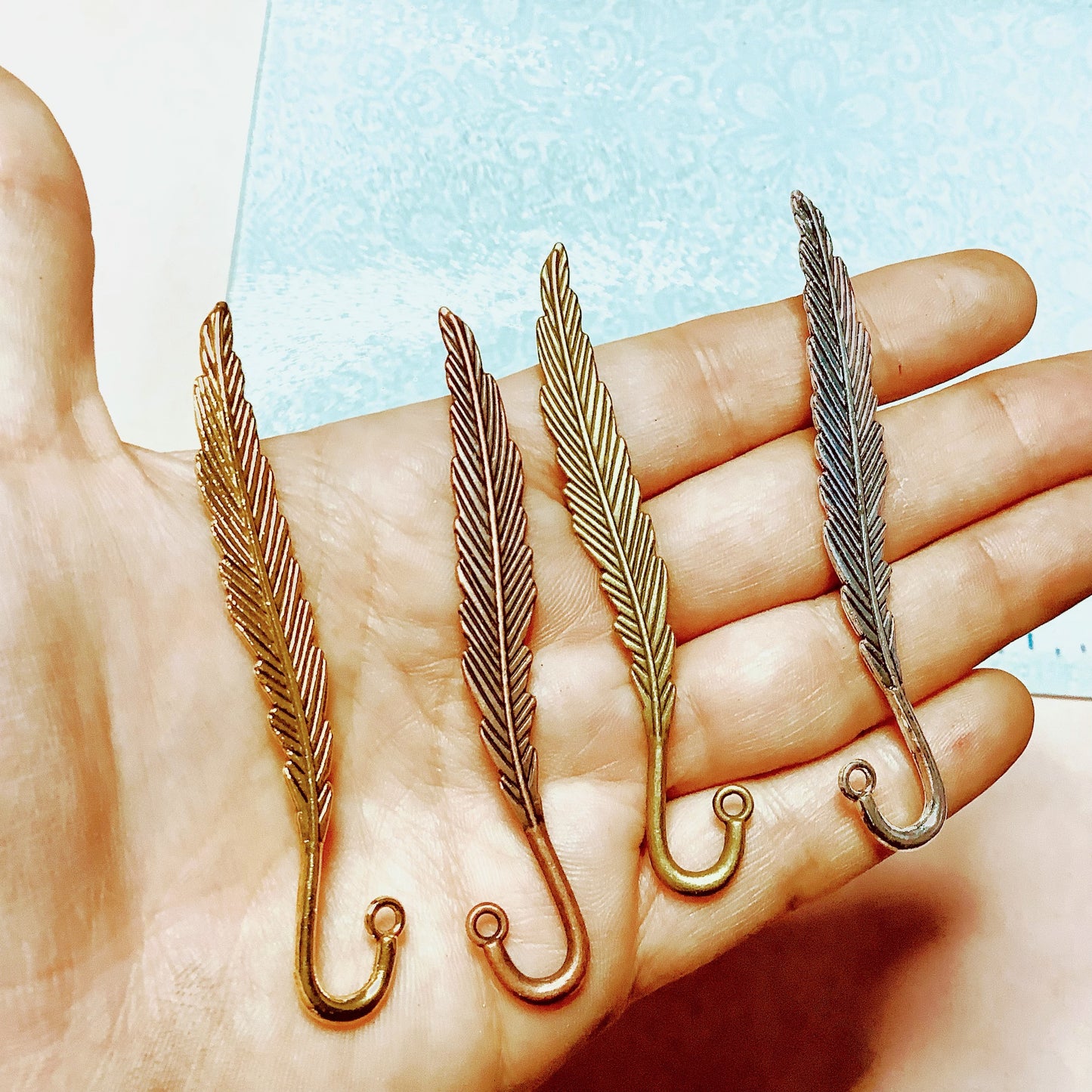 Feather hooked embossed metal bookmark