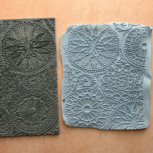 Blooming with Joy 3x4 inch rubber stamp beside impressed polymer clay slab showing full mandala floral pattern