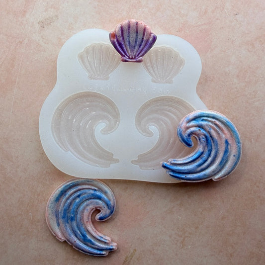 Shells and Swells silicone mold with baked polymer clay wave and shell earring pieces showing blue and pink shimmer finish