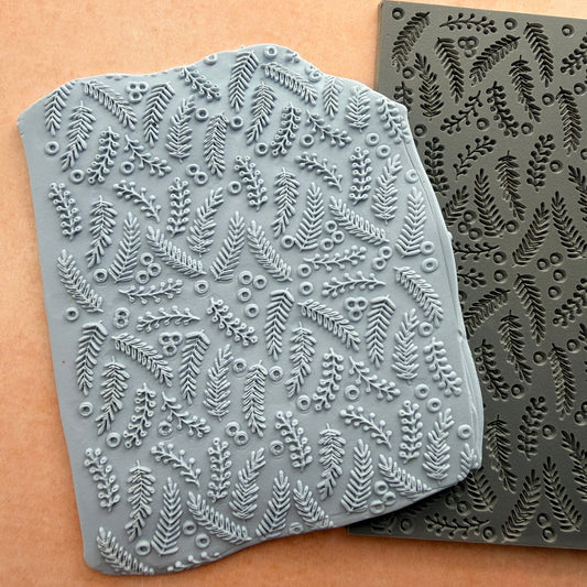 Brambleberries rubber stamp beside impressed polymer clay slab showing fern frond and berry pattern detail