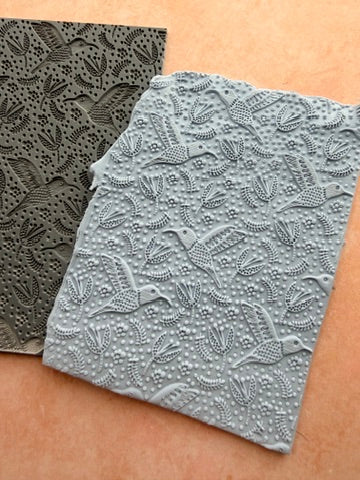 Hummingbird Flight rubber stamp for polymer clay close up showing hummingbird feather detail with dot clusters and botanical motifs